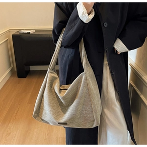 Detailed view of the large capacity dark grey textured fabric tote bag on model