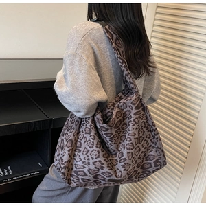 Leopard print faux suede tote bag shown on model for a natural casual silhouette