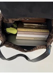 Top view of spacious leopard print tote interior showing storage for books and tablet