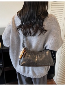 Retro charcoal faux leather hobo bag with vintage wooden bead charm and side strap detail