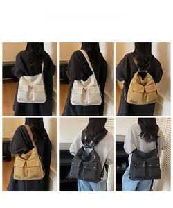 Functional canvas tote bag detail showing large flap pockets and multiple wearing styles
