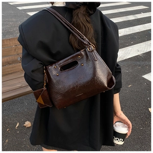 Detail of soft dark brown tote bag with vintage texture and mini hanging card holder