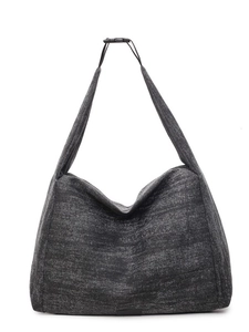 Minimalist dark grey tote bag with woven texture and buckle detail on shoulder strap