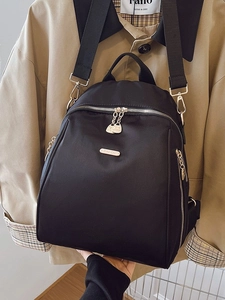 Minimalist black oxford fabric backpack with metal logo and adjustable straps
