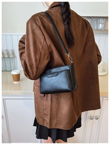 Minimalist black leather crossbody bag shown on model for daily commute style