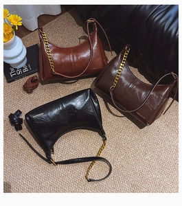 Three glossy leather shoulder bags in brown, coffee and black with golden chain straps