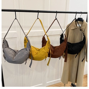 Detailed view of nylon hobo bags in four colors with drawstring details and wide straps