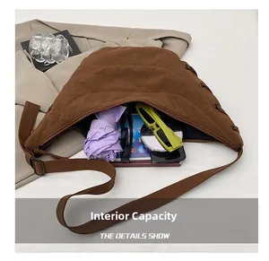 Deep brown crescent hobo bag interior capacity showing sunglasses, tablet, and umbrella