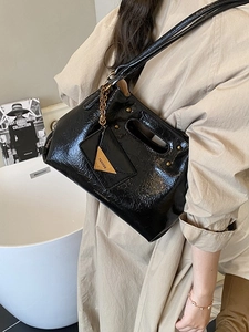 Glossy black wrinkled leather handbag with trendy triangle charm for office and casual style