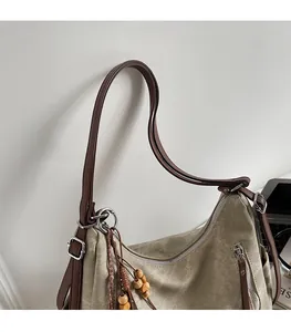 Close-up of adjustable leather strap and zipper detail on the retro khaki tote bag