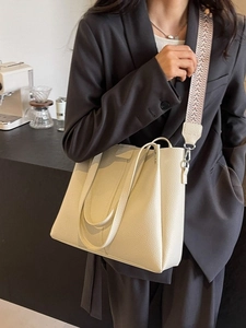 Beige oversized leather tote bag with vintage geometric woven strap for women's office style