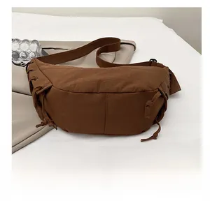 Detail shot of brown crescent bag with side drawstring and durable canvas texture
