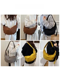 Detail view of large crescent dumpling bags in brown black grey and yellow colors
