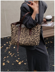 Spacious leopard print tote bag styled with casual professional outfit in outdoor setting