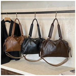 Detailed view of large capacity tote bags in light brown, black, and dark brown colors