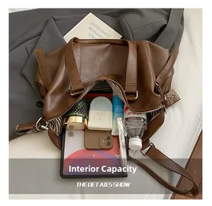 Detailed interior of a large brown tote showing spacious capacity for tablets and cosmetics
