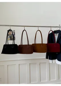 Collection of oversized suede tote bags in black, dark brown, caramel, and burgundy colors