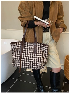 Brown houndstooth tote bag with leather straps styled in a modern lifestyle setting