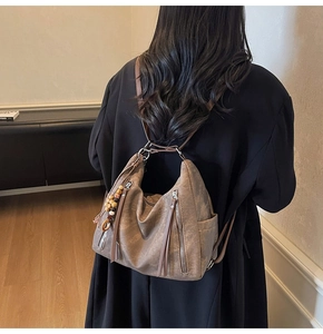Brown vintage faux leather tote detail featuring stylish fringe zipper and ethnic beads