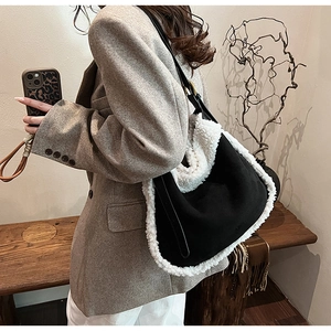 Detail showing autumn black suede crossbody bag with white faux fur trim on model