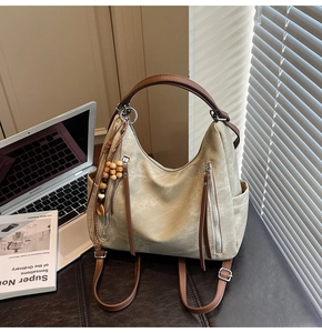 Detail view of retro beige versatile tote bag with wooden bead charm in a lifestyle setting