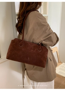 Minimalist dark brown suede tote bag styled with a khaki trench coat for a retro vibe