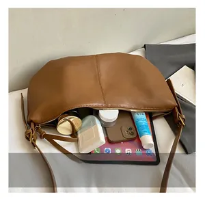 Internal view of large brown soft leather tote bag showing spacious storage for daily items