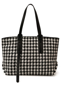 Classic houndstooth patterned tote bag with black leather straps on white background