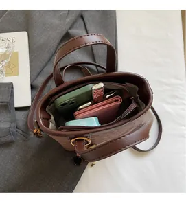 Interior view of brown leather bucket bag showing spacious main compartment and zipper pocket