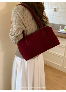 Minimalist large burgundy suede tote bag shown on model back for retro commuter style