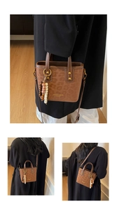 Close-up of leopard print bucket bag with ethnic tassel and adjustable strap