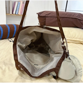 Brown nylon tote bag detail showing large interior space and a small round coin purse