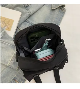 Vista interna della borsa a tracolla in nylon nero con vari scomparti per una conservazione ordinata