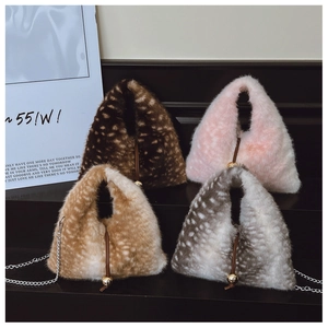 Detail of furry triangle bag with leopard print, drawstring closure and gold ball decor