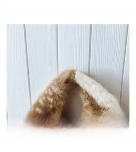 Close-up of fluffy faux fur handbag handle with brown and white animal spot texture