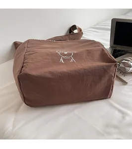 Detail of a durable dark brown tote bag with animal print on a white lifestyle background