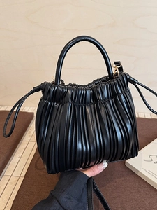 Chic black pleated bucket bag with top handle and gold-tone hardware for women