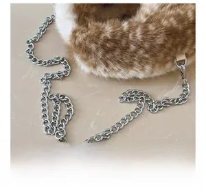Detail of silver chain strap and fuzzy spotted faux fur texture on the triangle bag