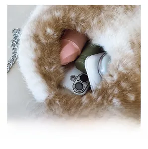 Detail view showing interior capacity of plush fur chain bag with gold ball charm