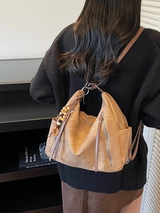 Brown vintage faux leather backpack with metallic zippers and decorative beads