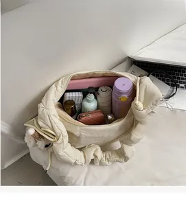 Spacious interior of beige quilted cloud bag showing large capacity for daily essentials