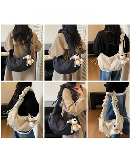 Detail view of large quilted cloud tote bag with ruched shoulder strap and cute bear charm