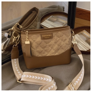 Detail showing retro quilted lattice texture and brown faux leather on crossbody bag