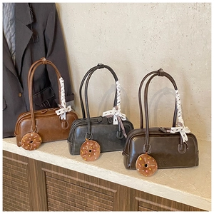 Detail view of vintage baguette bags with lace bows and cute donut plush charms
