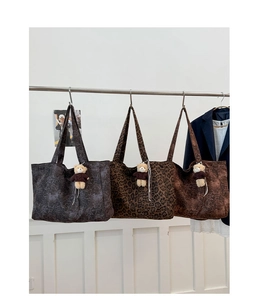 Detailed shot of leopard print tote bags in three colors with cute bear charms