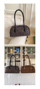 Close-up of vintage baguette bags featuring leopard prints and leather shoulder straps