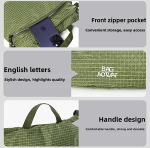 Detail view of green checkered bag with zipper front pocket and durable handle straps