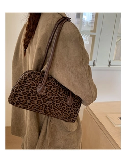 Detail showing leopard print shoulder bag with brown leather strap and white stitching