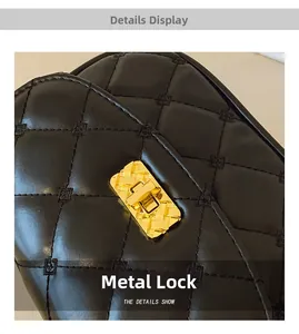Macro detail of golden metal clasp with braided texture on black quilted leather bag