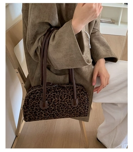 Detail view of vintage leopard print baguette bag with soft velvet texture and leather straps